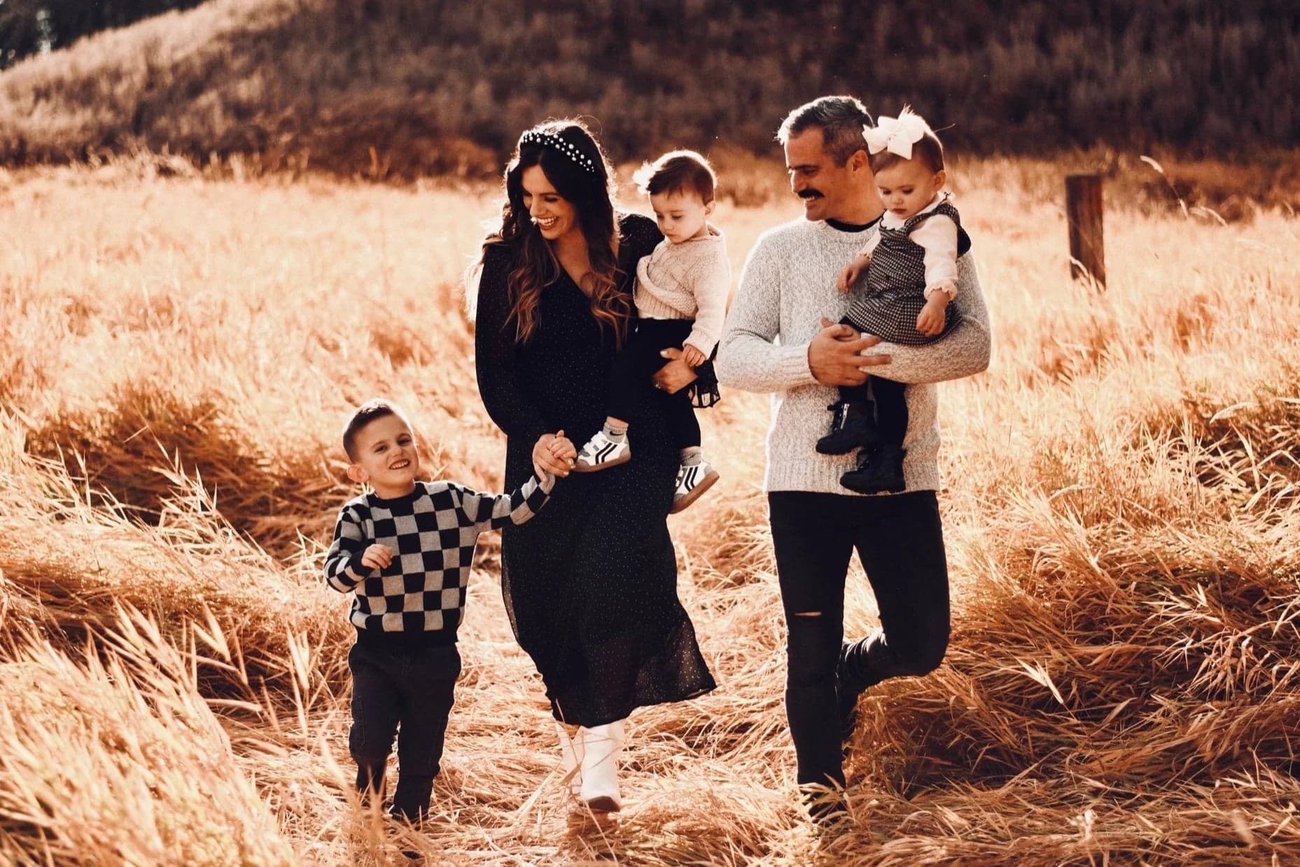 Bingle with his family walking through a golden field
